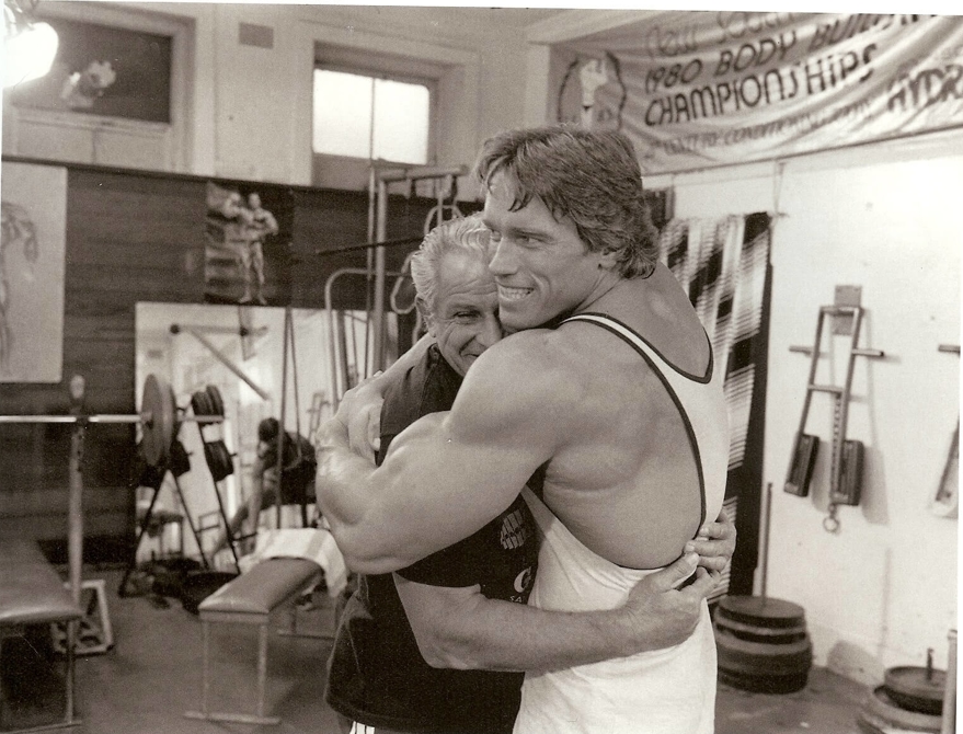 Arnold schwarzenegger hugging Joe Gold